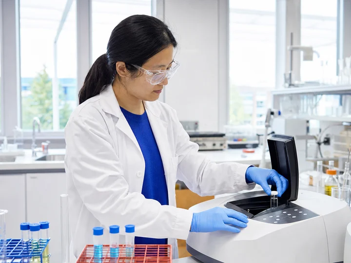 A post-secondary laboratory technician preparing teaching equipment.
